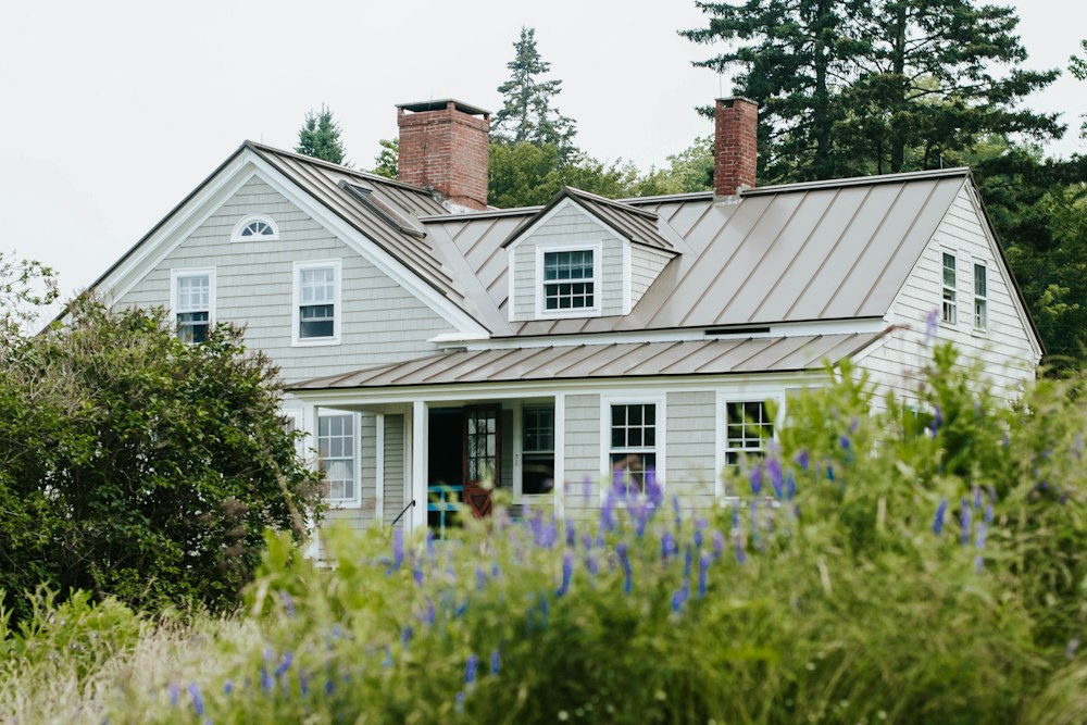 A white home with a green front yard