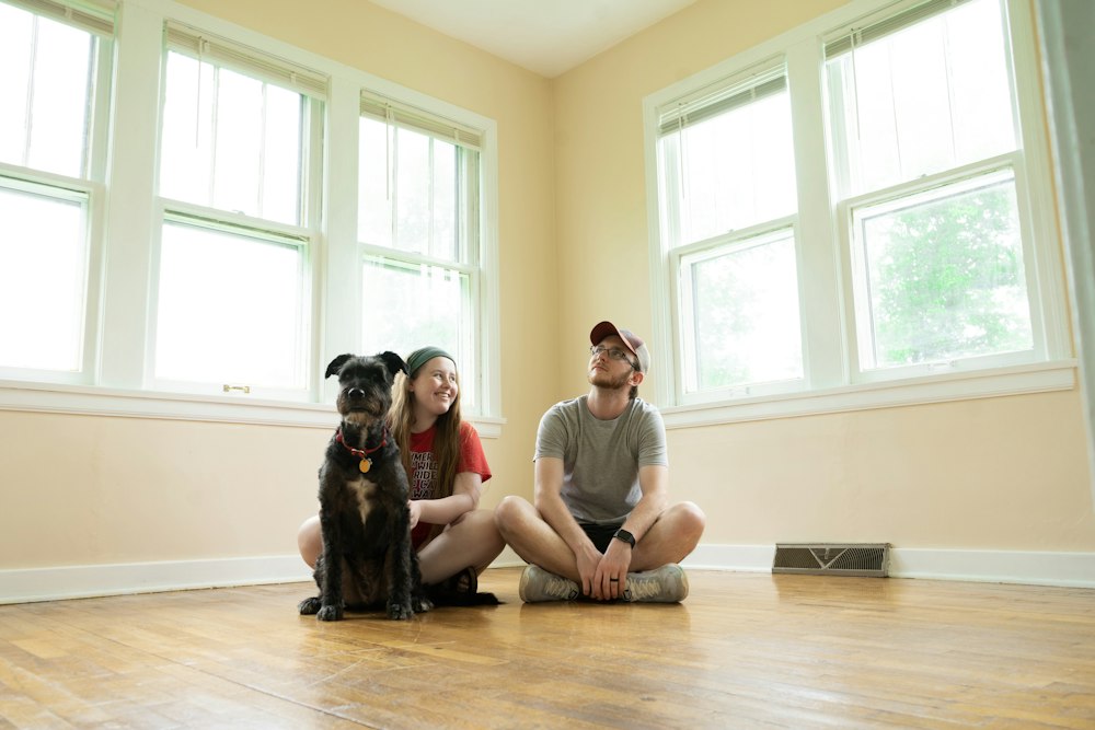 A couple and their dog sitting in their new home