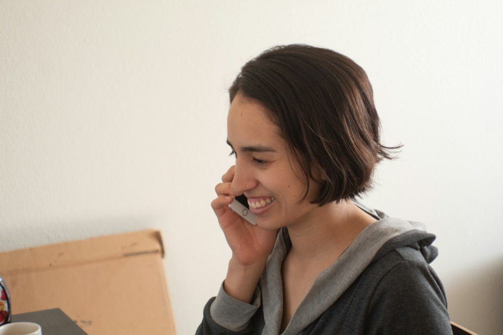 A woman laughing on a phone call